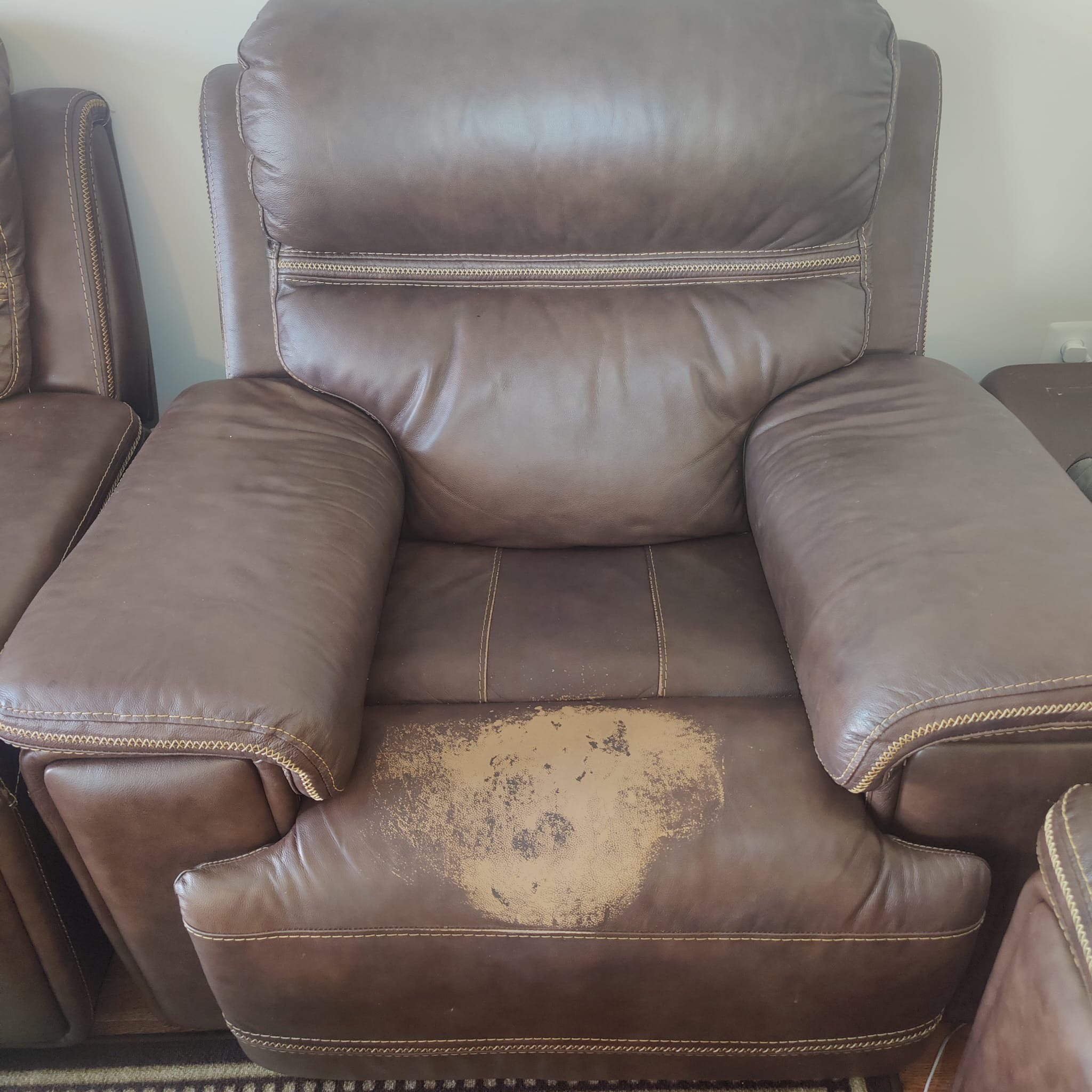Damaged leather couch before restoration