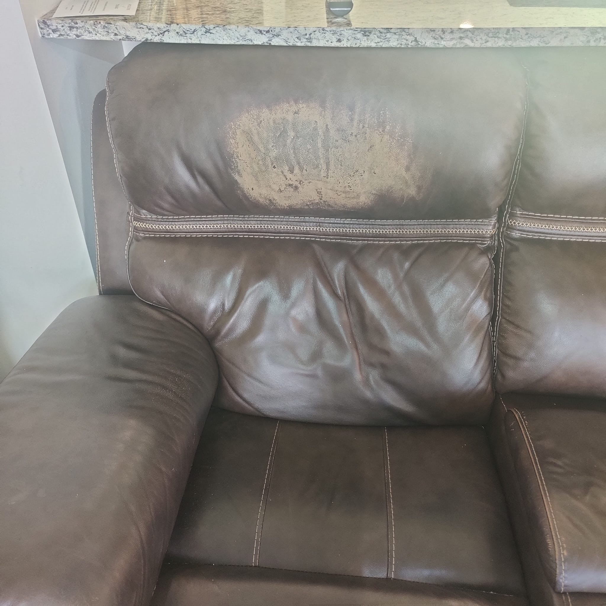 Damaged leather couch before restoration