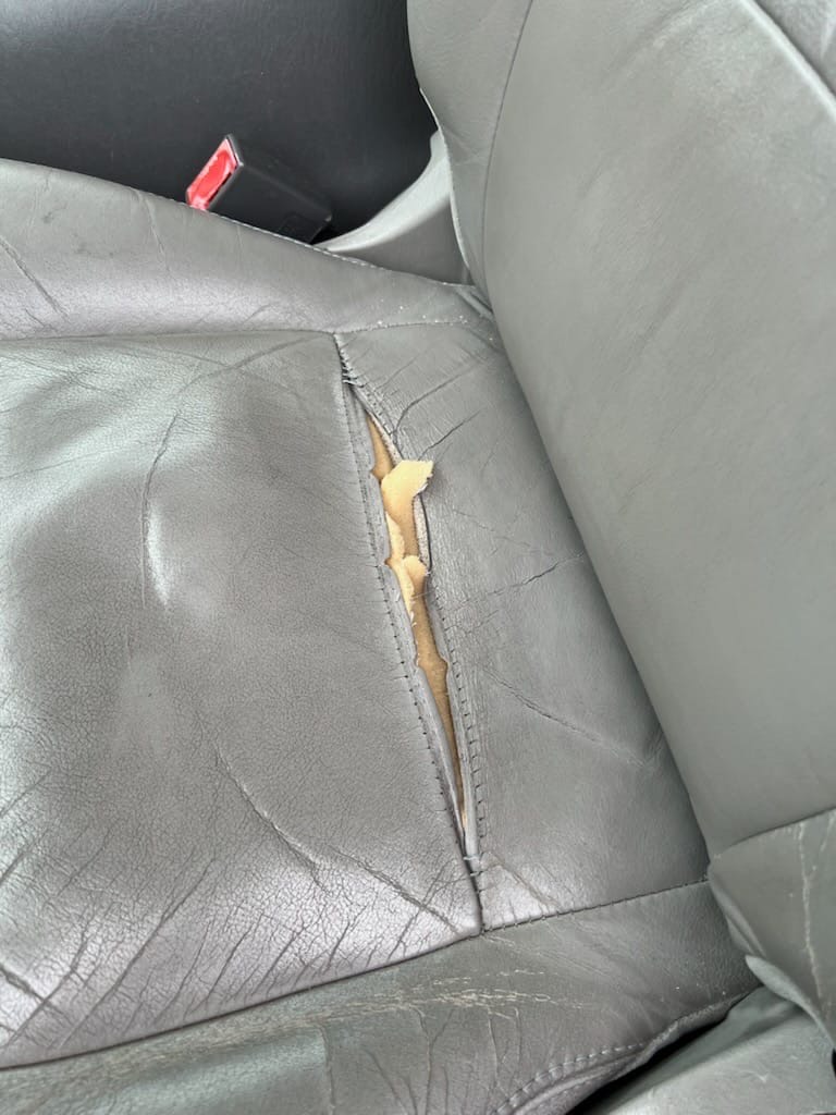 Damaged car seat before restoration