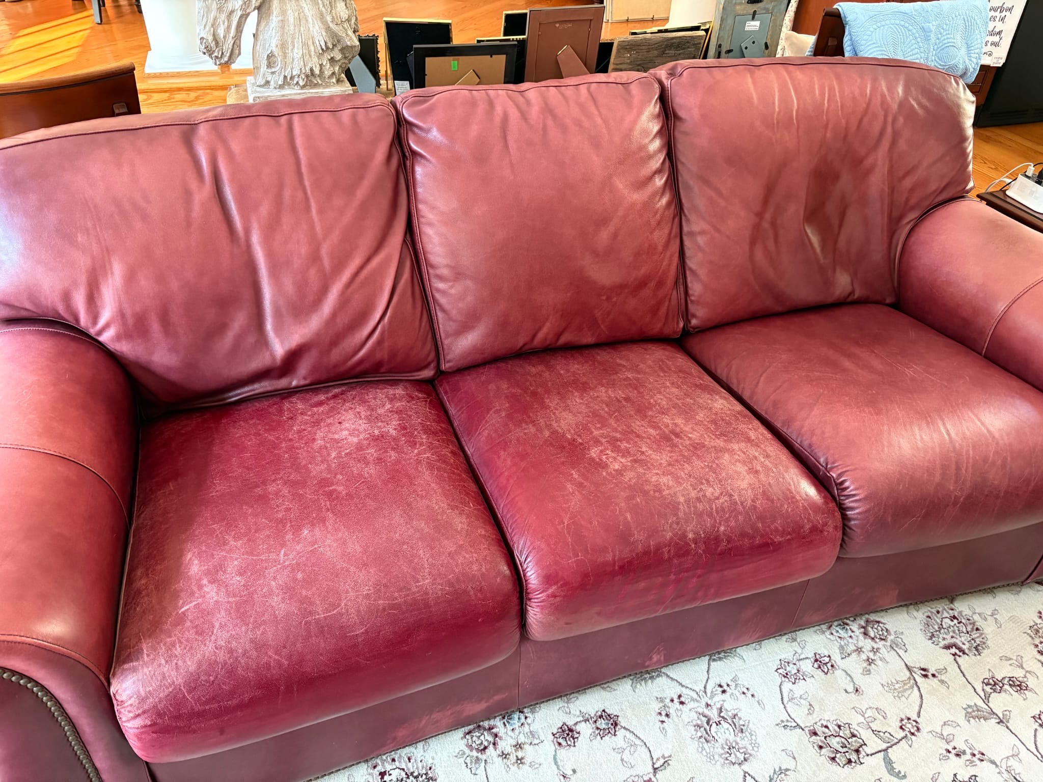 Damaged leather couch before restoration