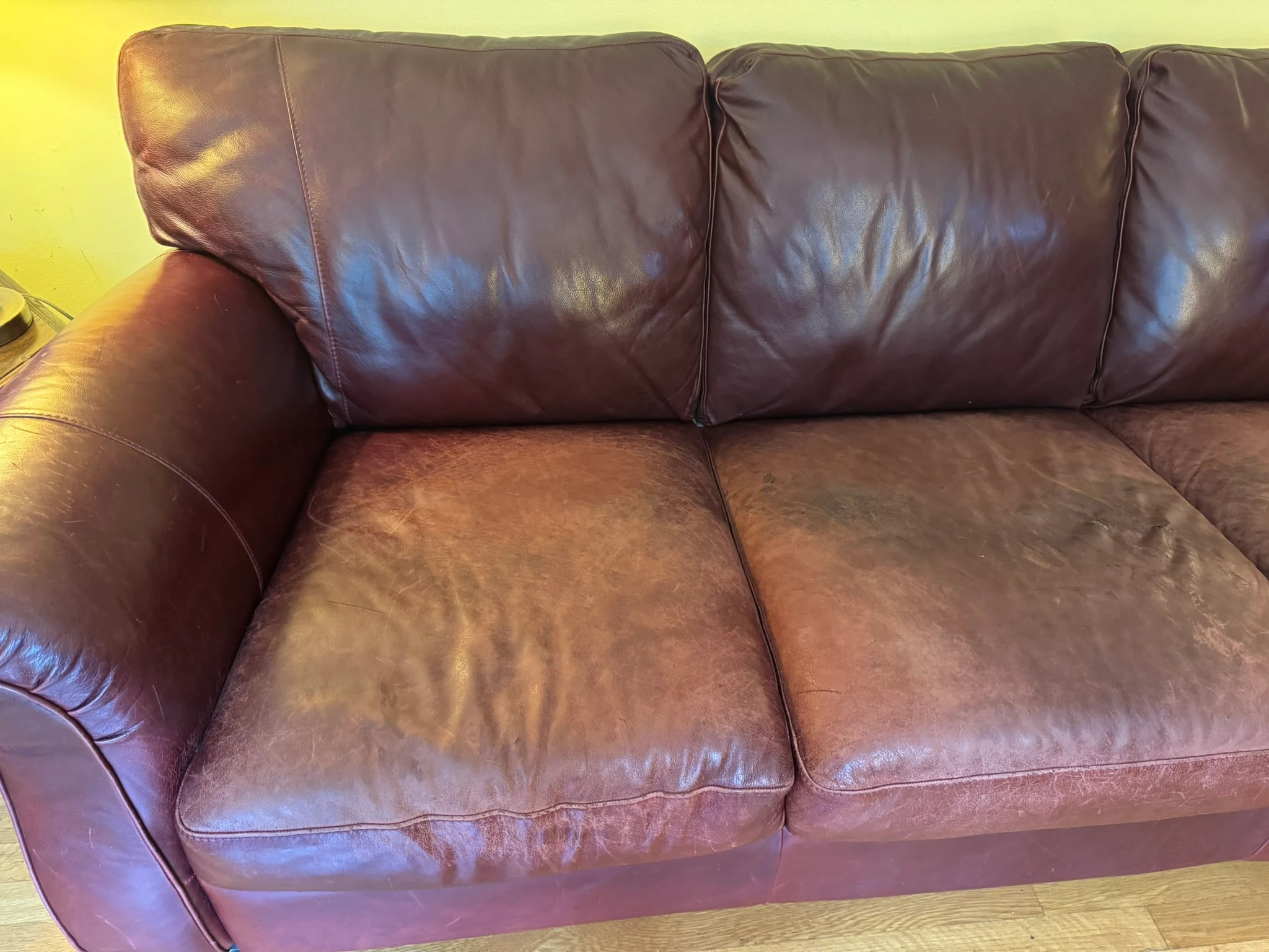 Damaged leather sofa before repair