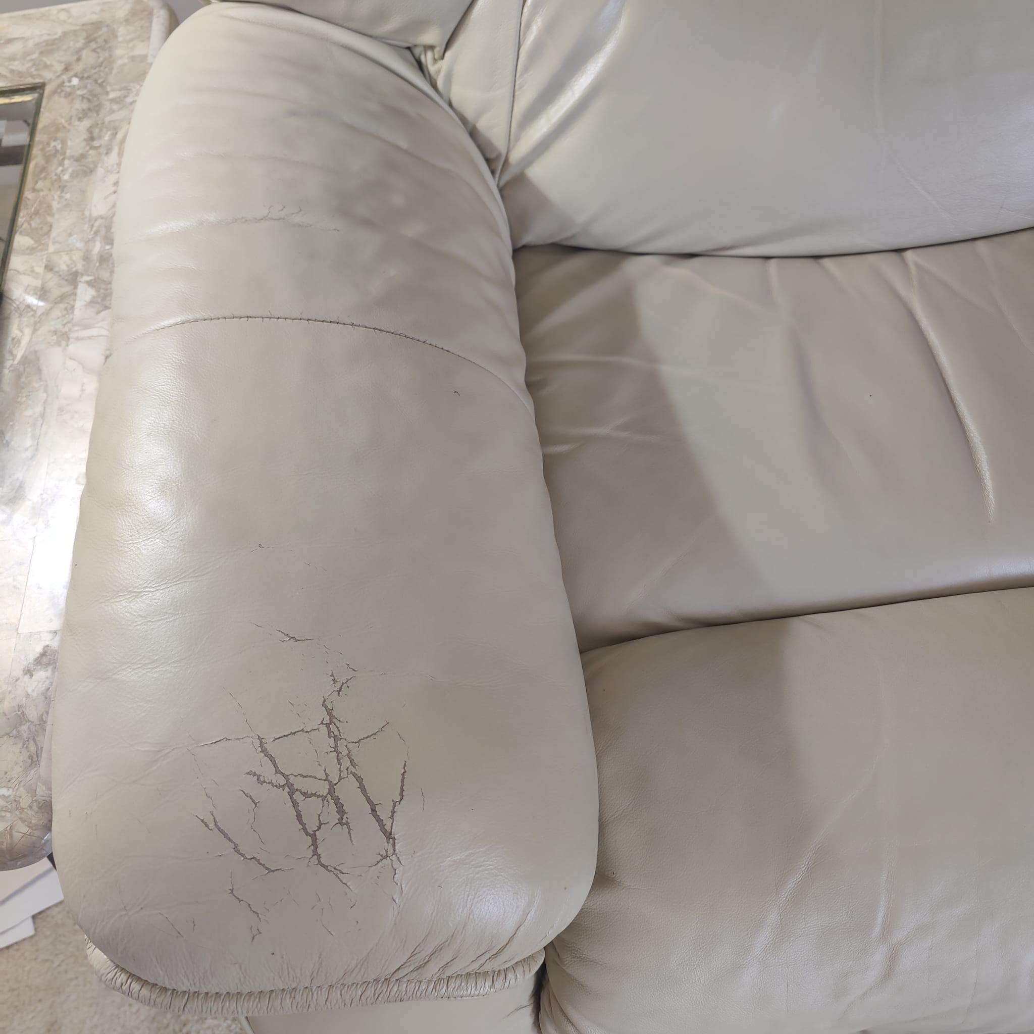 Damaged leather couch before restoration